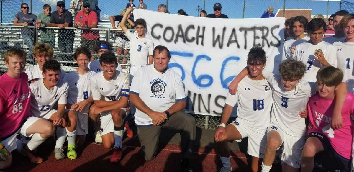 Old Saybrook boys soccer coach Steve Waters is surrounded by his team after he won his 566th career game, setting a new CIAC record on Sept. 10, 2021. Waters won his 600th career game on Nov. 11, 2022 when Old Saybrook defeated Litchfield 2-0 in the CIAC Class S state quarterfinals.