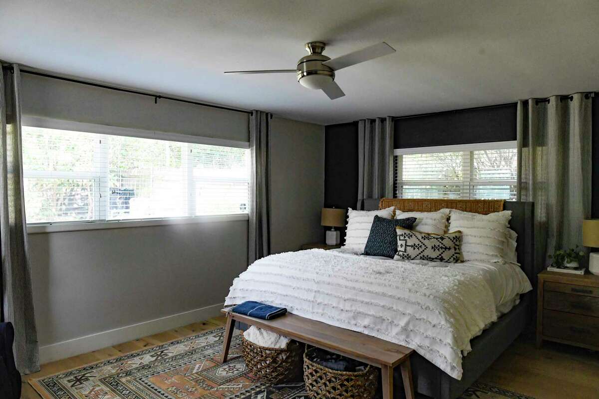 Three walls in the master bedroom are painted a calming gray while the fourth is black, which she said helps make the room seem larger.