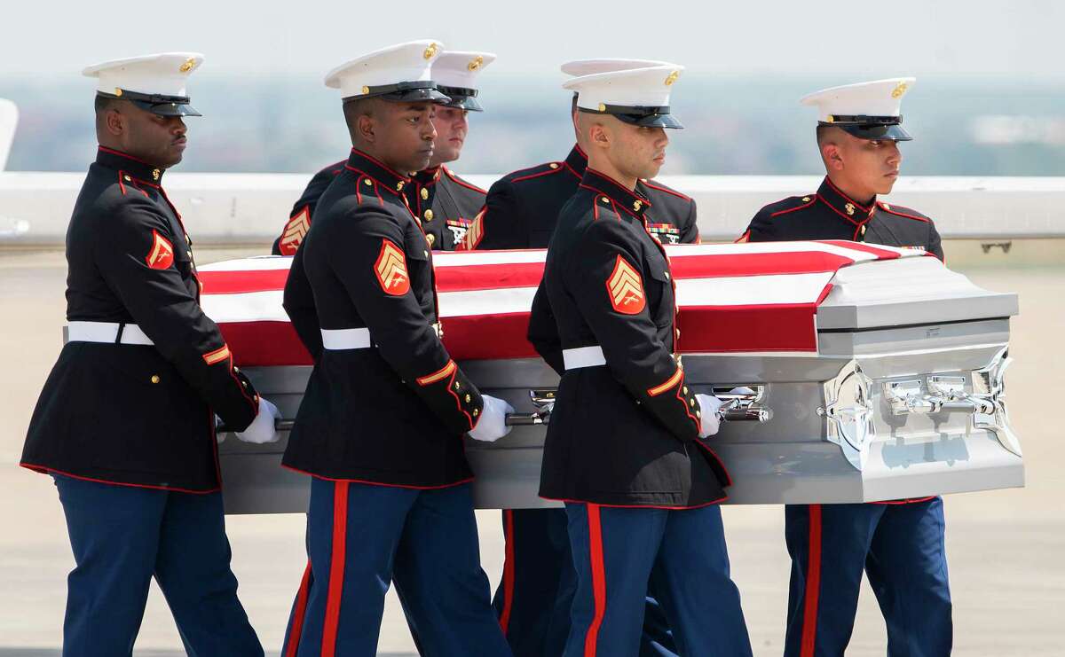A group of United States Marines move the body of Lance Corporal David Lee Espinoza during a Dignified Transfer to the hearse, Friday, Sept. 10, 2021, after arriving at the Laredo International Airport.