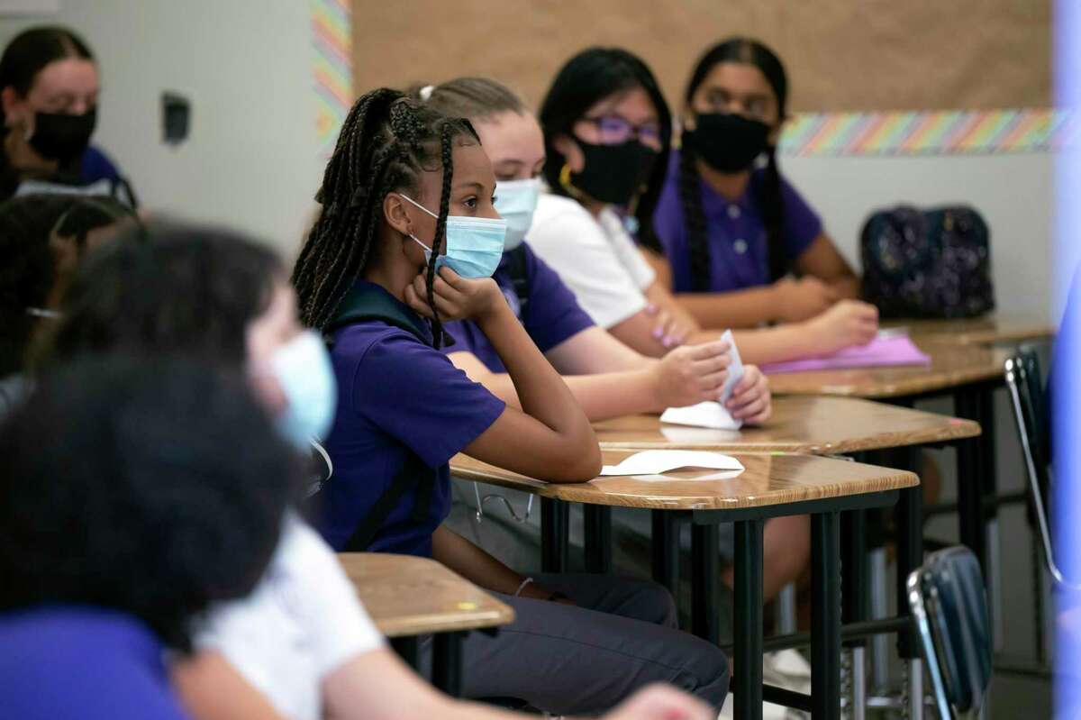 Masked students attend the Girls Academic Leadership Academy in Los Angeles last month.