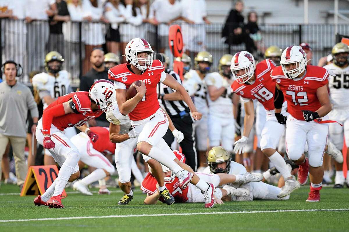 Fairfield Prep QB Connor Smith breaks a tackle to score a first-half touchdown against Daniel Hand on Friday at Rafferty Field in Fairfield.