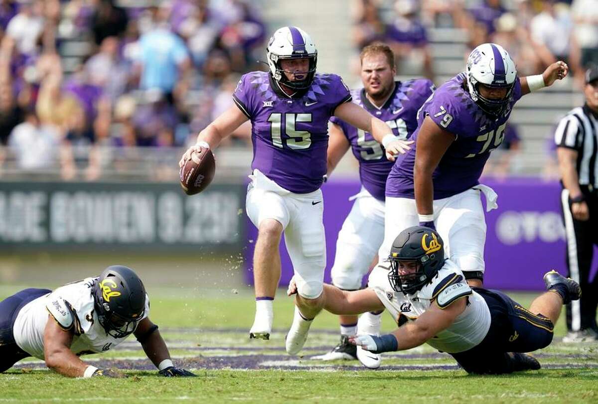TCU quarterback Max Duggan (15) carries the ball past California defensive end JH Tevis (47) and others for a gain in the first half of an NCAA college football game in Fort Worth, Texas, Saturday, Sept. 11, 2021. (AP Photo/Tony Gutierrez)