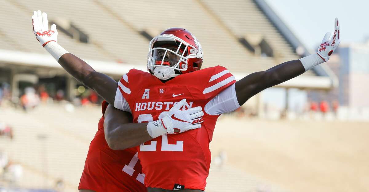 Houston Cougars running back Alton McCaskill (22) celebrates after scoring a 35-yard receiving touchdown against the Rice Owls during the first quarter of an NCAA game at Rice Stadium on Saturday, Sept. 11, 2021, in Houston.