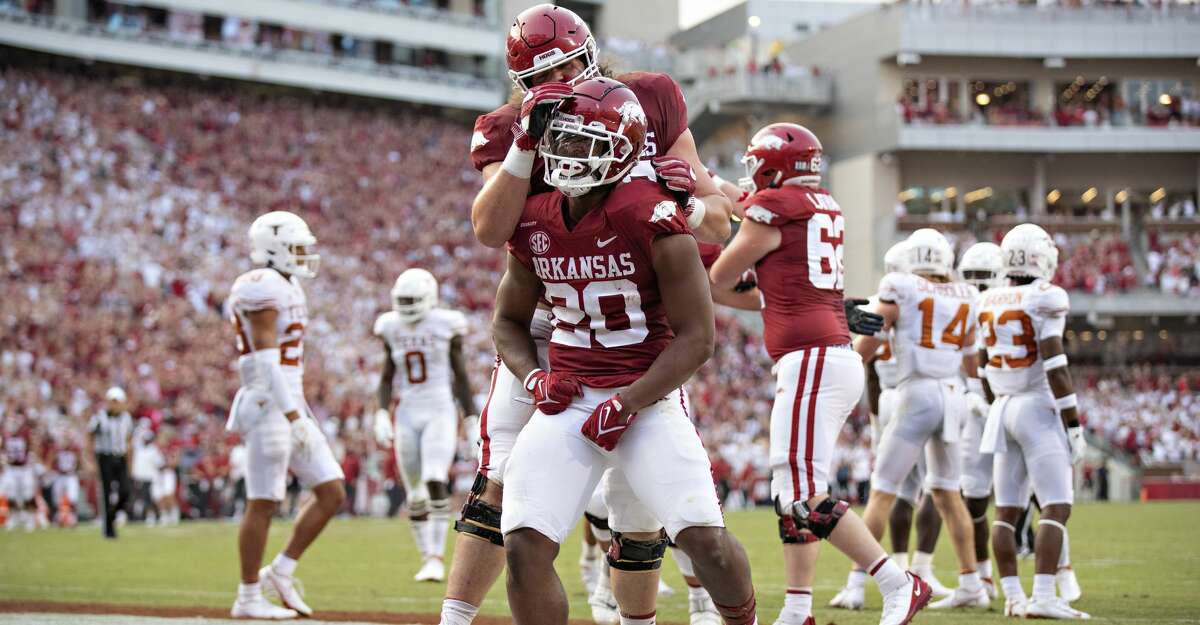 Dominique Johnson #20 of the Arkansas Razorbacks celebrates after scoring a touchdown in the first half of a game against the Texas Longhorns at Donald W. Reynolds Razorback Stadium on September 11, 2021 in Fayetteville, Arkansas. (Photo by Wesley Hitt/Getty Images)