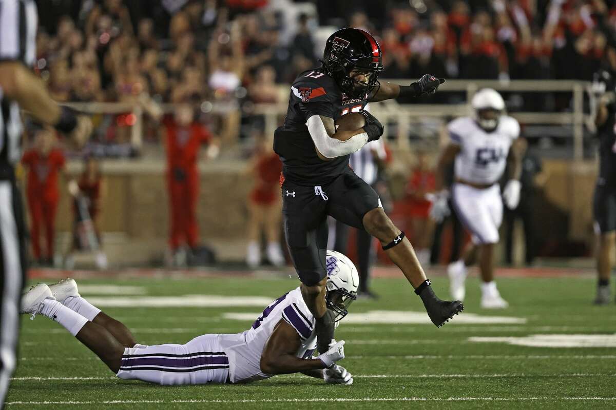 Texas Tech's Erik Ezukanma (13) breaks a tackle attempt by Stephen F. Austin's Bruce Harmon (23) during the second half of an NCAA college football game Saturday, Sept. 11, 2021, in Lubbock, Texas. (AP Photo/Brad Tollefson)