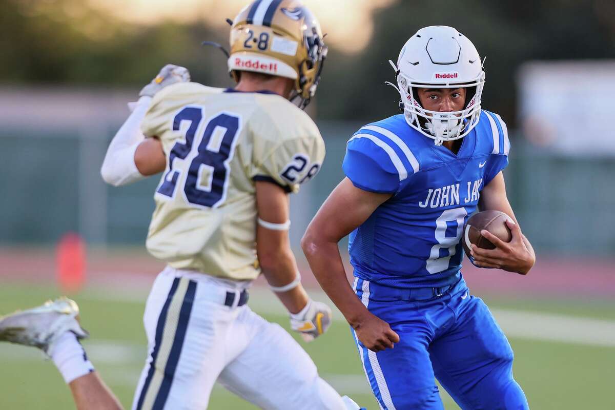 John Jay quarterback Jackson Gutierrez, right, looks to get past O'Connor's Dylan Parisher during the first half of their District 29-6A high school football game at Gustafson Stadium on Saturday, Sept. 11, 2021. Jay beat O'Connor 35-25.