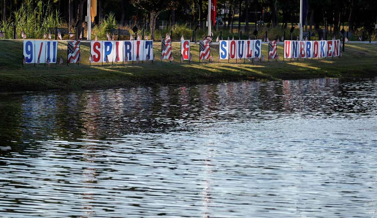 A sign that reads “9/11 Spirit & Souls Unbroken” is seen during a ceremony at the Montgomery County Veterans Memorial Park in honor of the 20th anniversary of the 9/11 terrorist attacks, Saturday, Sept. 11, 2021, in Conroe.