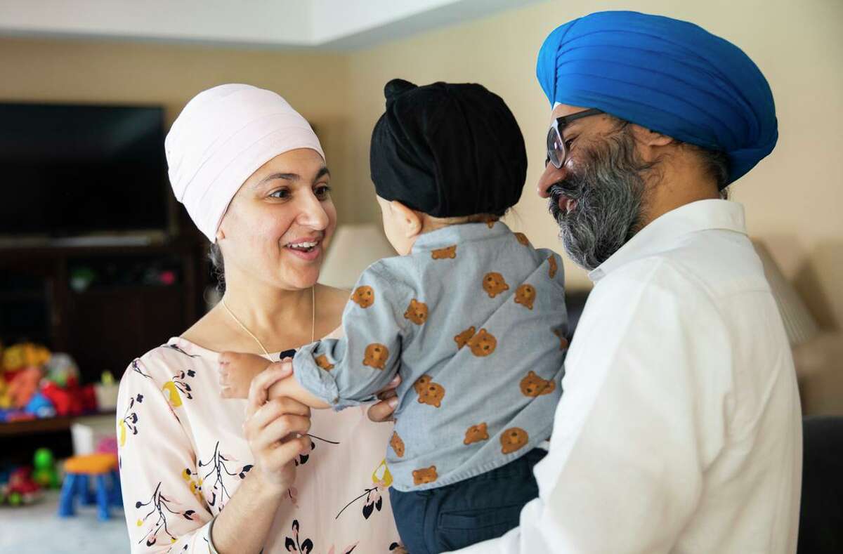 Kavneet Singh, who chairs the Sikh American Legal Defense and Education Fund, and his wife, Karen Singh, spend time with their 14-month-old son at their home in Danville.