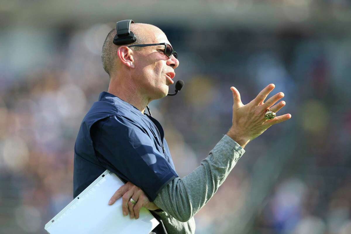 Connecticut interim head coach Lou Spanos gestures from the sideline during the first half of an NCAA football game against Purdue on Saturday, Sept. 11, 2021, in East Hartford, Conn. (AP Photo/Stew Milne)
