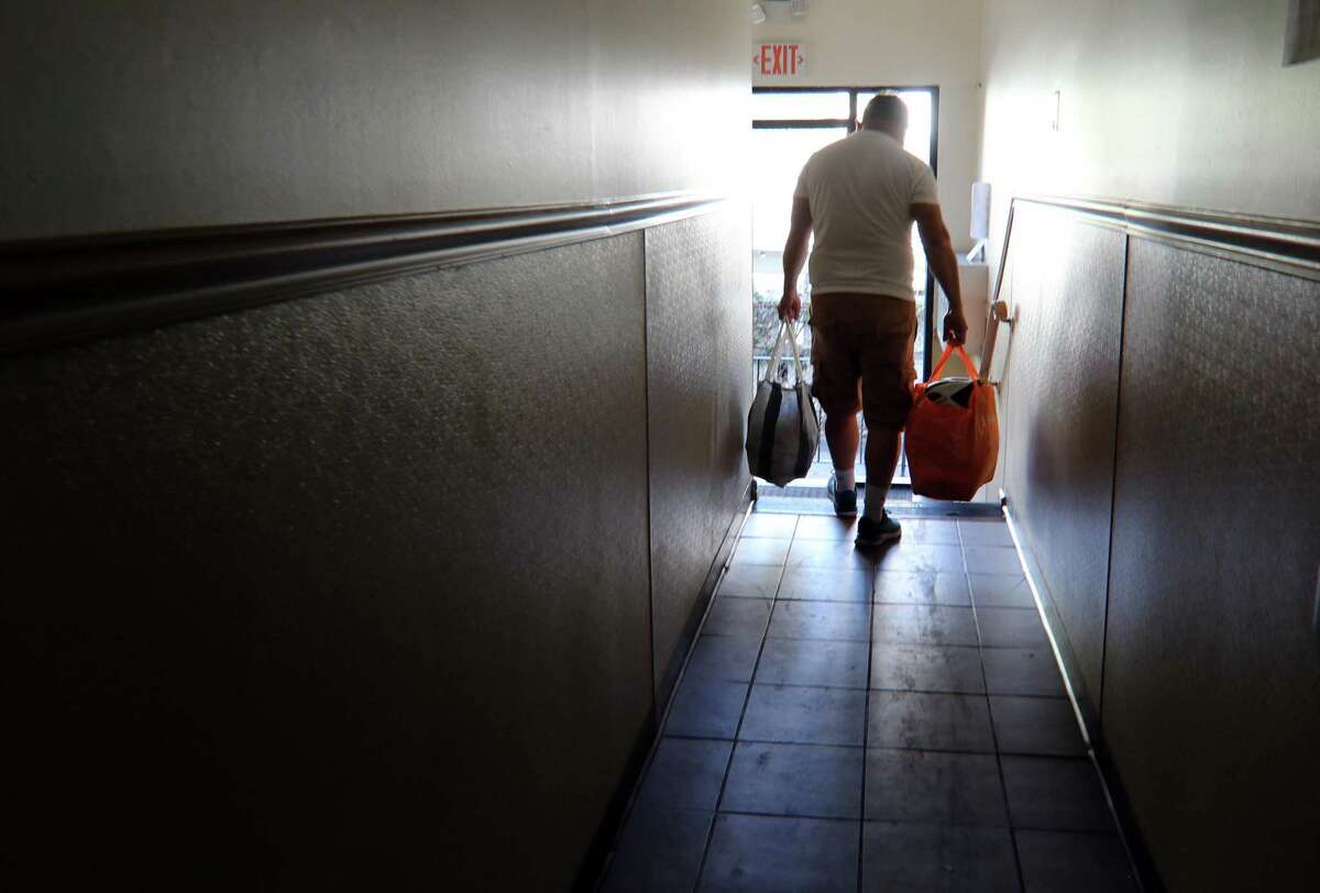 A resident moves his belongings from his unit at Cove Road Apartments in Stamford, Conn., on Tuesday Sentember 7, 2021. Remnants of Hurricae Ida last week caused damage to the apartments, forcing residents to find alternative housing.