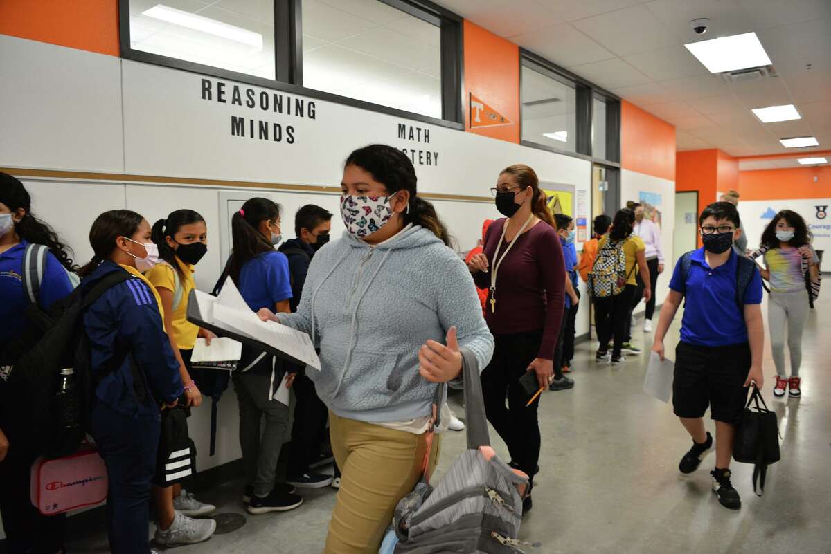KIPP Aspire Academy students transition between classes. The charter network requires all students and teachers to wear masks.