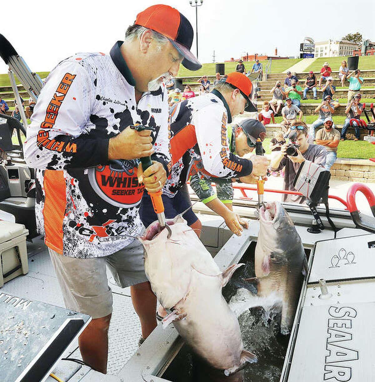 From the left, Charles LaPlant, Mike Davis and Hunter Jones, all from Springfield, Illinois, hoist up their catch Saturday at the 2021 Alton Catfish Classic so it can be weighed. The three were among 100 teams of fisherman competing in this year’s event. The men landed one fish over 67 pounds and had a total weight of more than 129 pounds. The first place prize of $15,000 was won by Justin Neece of Odessa, Missouri, and John Jamison of Wellsville, Kansas with 161.38 pounds. Additional photos are online at thetelegraph.com. - John Badman|The Telegraph