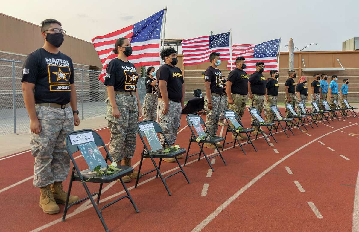 Students from Cigarroa, Martin and Nixon High Schools who participate in JROTC pay tribute to Lance Corporal David Lee Espinoza at Shirley Field on Friday, Sept. 10, 2021 prior to a football game between Cigarroa and LBJ.