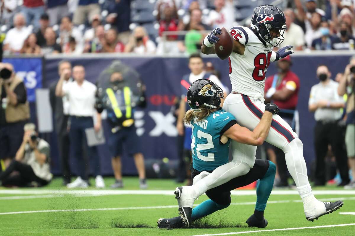 Houston Texans tight end Pharaoh Brown (85) drags Jacksonville Jaguars safety Andrew Wingard (42) forward after making a reception during the third quarter of an NFL football game Sunday, Sept. 12, 2021, in Houston.