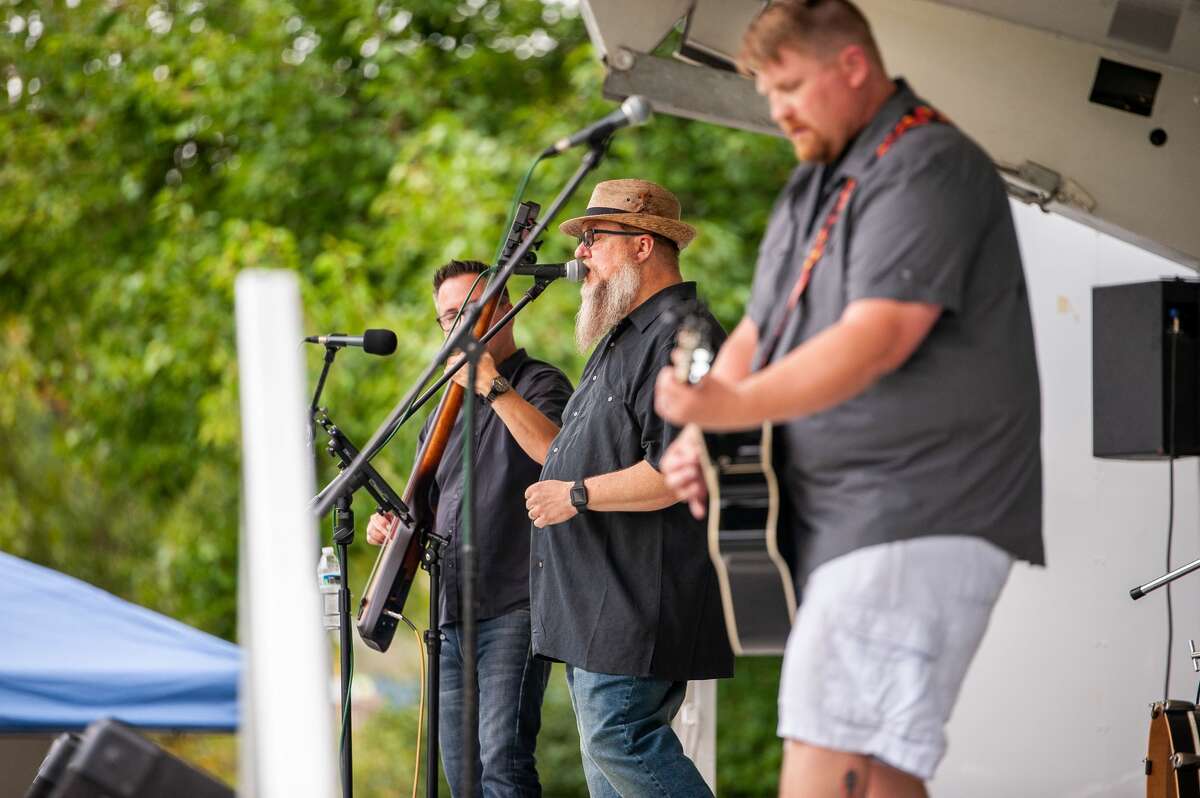 People enjoy and play music during the Parkapalooza event at Chippewassee Park in Midland on Sept. 12, 2021. This year marks the first time the festival has taken place in Midland. 