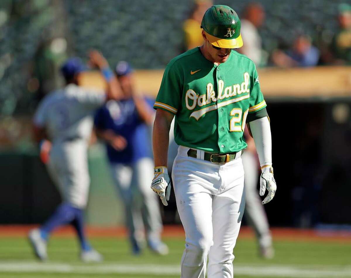 The A’s Mark Canha walks off the field after making the final out in the loss to the Rangers at the Coliseum.