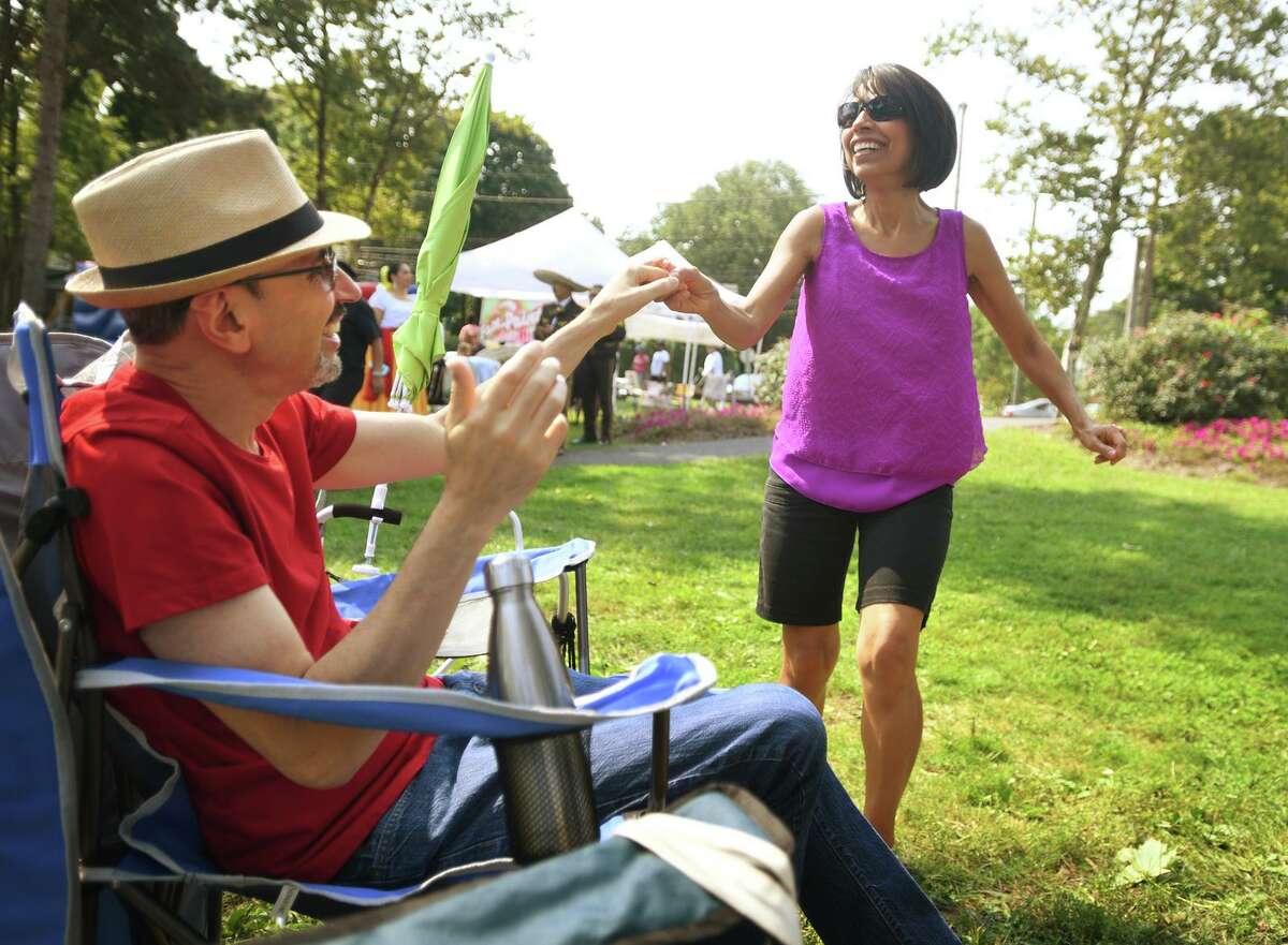 Felix and Brunie Arbelo, of Stratford, move to the music at the Stratford Latin Music Festival on Paradise Green in Stratford, Conn. on Sunday, September 12, 2021.