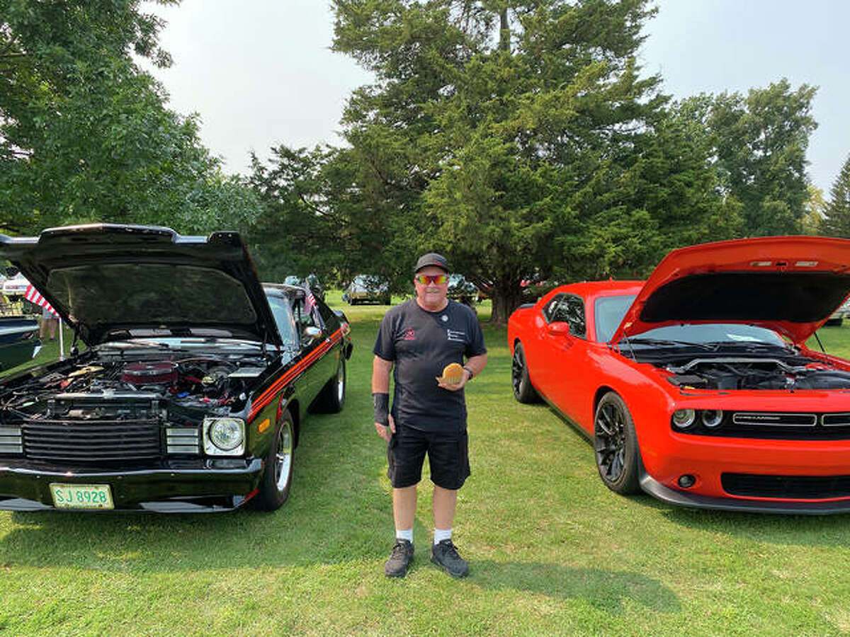 Kicks on 66 attracts a lot of enthusiasts from all four directions. David Lovel from Edwardsville stands between both of his cars, Saturday, a modern Dodge Challenger on the right and a classic Dodge Aspen R/T on the left.