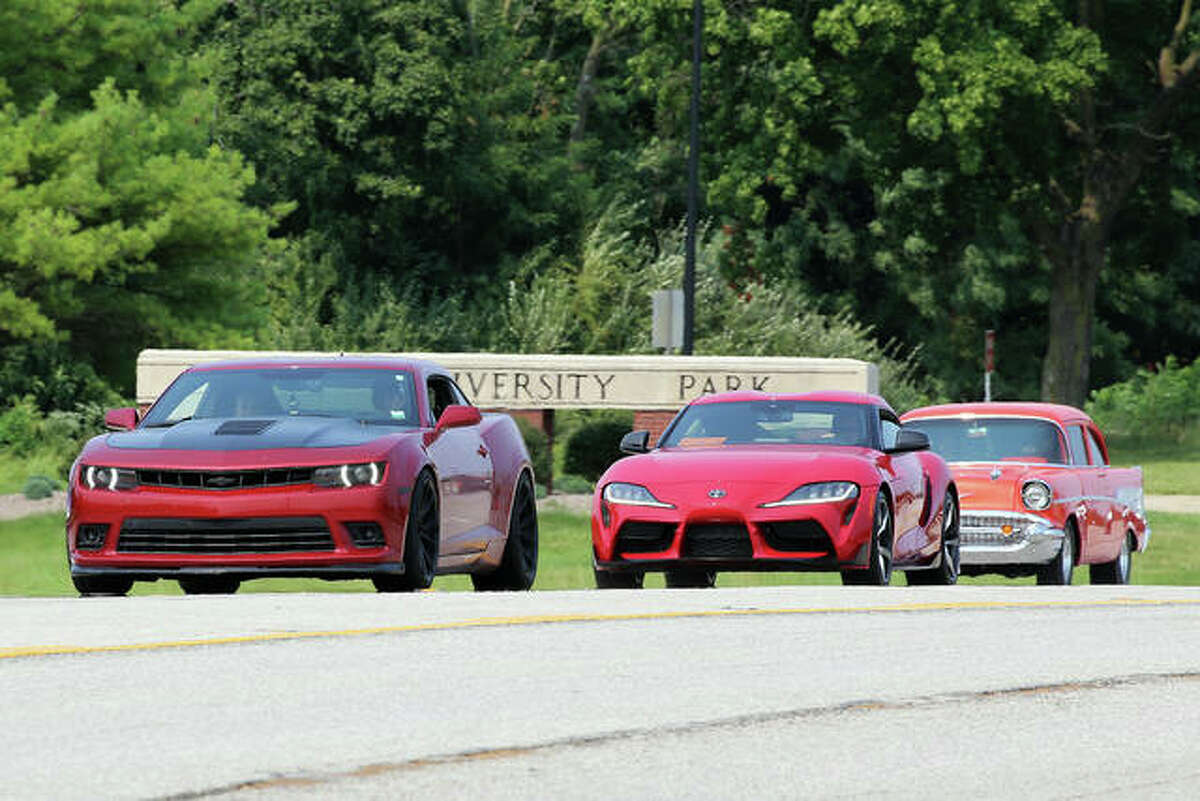 Participants crusing in the Kicks on Route 66 Ultra Car Show and Cruise in Edwardsville Saturday. In back is a 1957 Chevrolet while in front is a modern Chevrolet Camaro. Sandwiched between them is a new Toyota Supra.