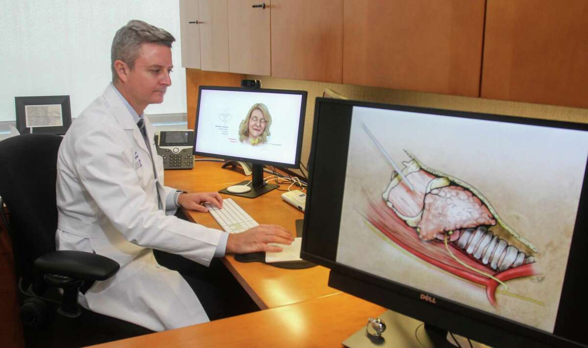 Dr. Raymon Grogan, associate professor of surgery at Baylor College of Medicine and section chief of endocrine surgery at Baylor St. Luke’s Medical Center, reviewing images of the thyroid at Baylor's McNair Campus in Houston on August 16, 2021. Dr. Grogan is also with the Dan L Duncan Comprehensive Cancer Center at Baylor College of Medicine