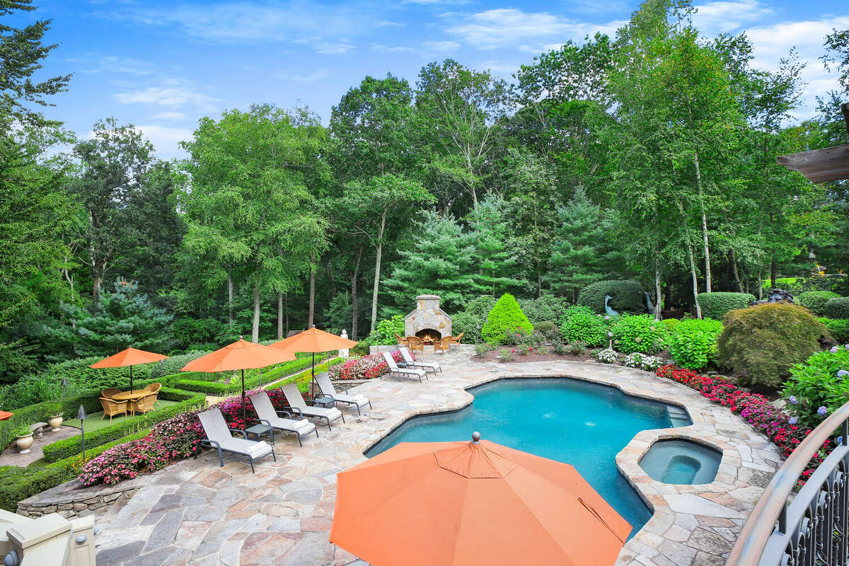 The home on 30 Crossbow Lane in Easton, Conn.  has a pool, spa and outdoor fireplace. 