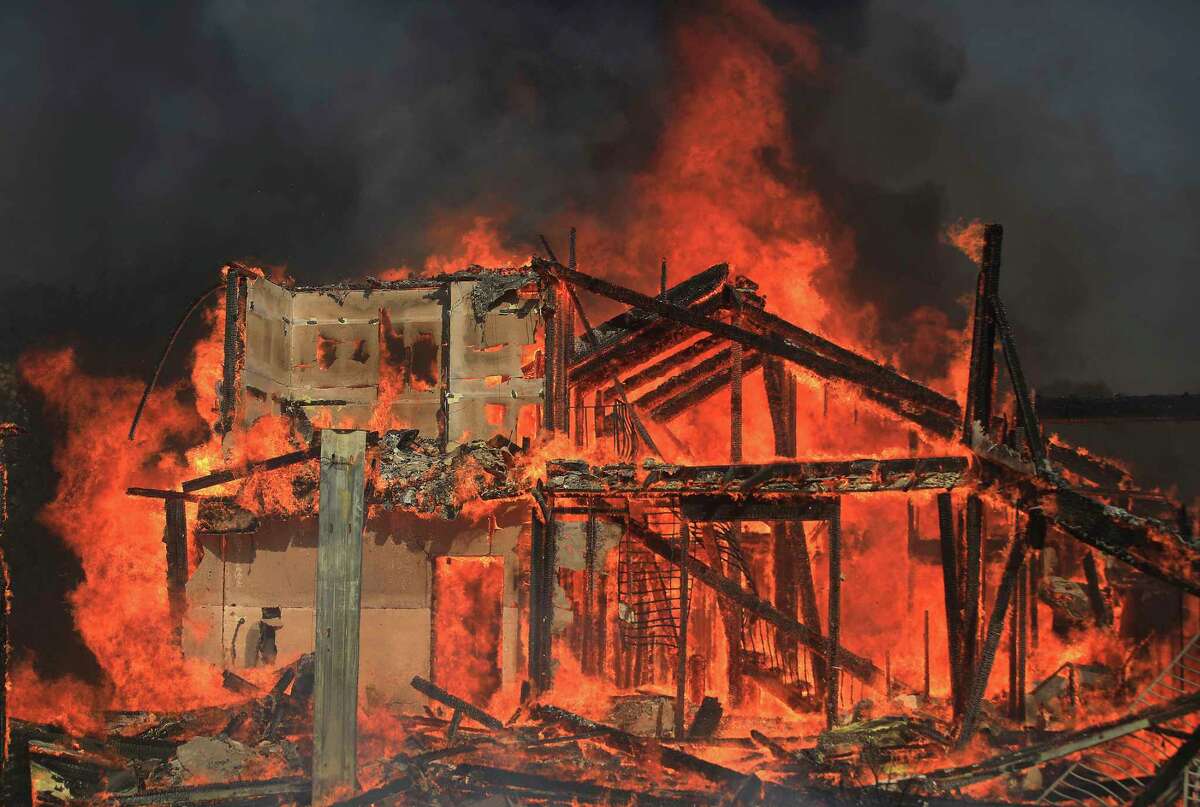 A home burns on Marina Drive above Lake Mendocino during the Hopkins fire, Sunday, Sept. 12, 2021 in Calpella, Calif., in Mendocino County. (Kent Porter/Santa Rosa Press Democrat via AP)
