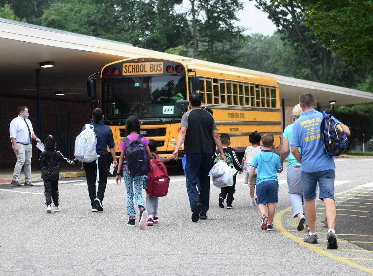 Students enter the first day of school at Newfield Elementary School in Stamford, Conn. Monday, Aug. 30, 2021.