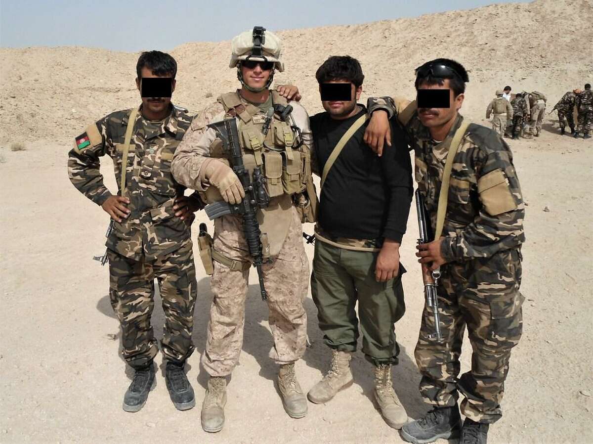 State Rep. Matt Blumenthal, D-Stamford, during a 2011 deployment to Afghanistan with the U.S. Marine Corps. He is shown with Afghan soldiers whose faces have been obscured to protect their identities after the fall of the government there.