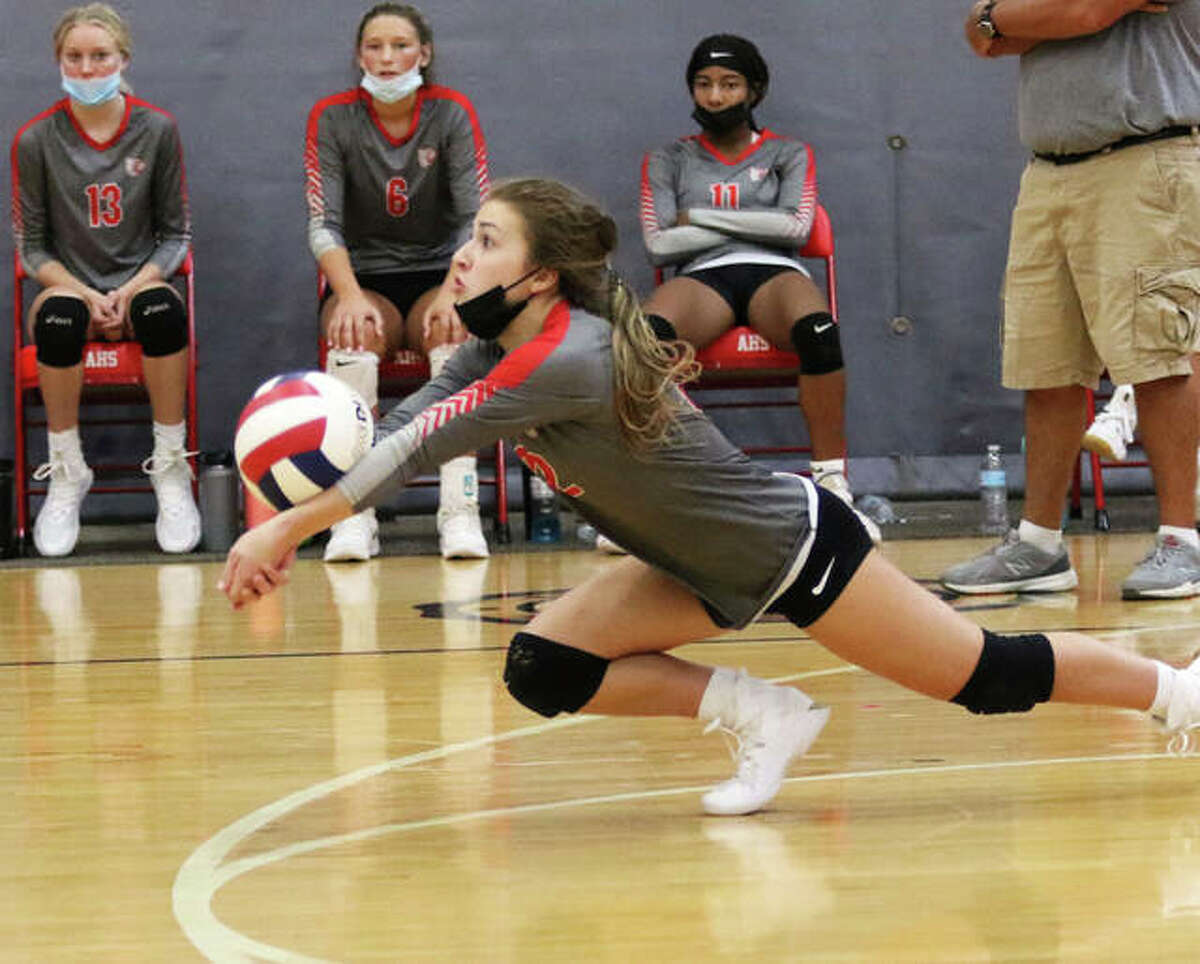 Alton defensive specialist Payton Olney dives to make a dig Saturday against Granite City in a third-place match at the Alton Tourney in Godfrey.
