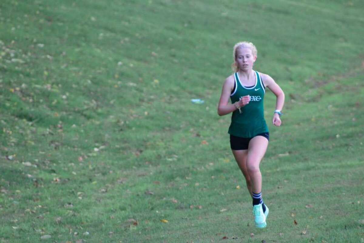 New Milford senior Maddie Sweeney returns as one of the state's top high school girls cross country runners ahead of the 2021 season. Sweeney had a successful junior season after bettering her sophomore times by over four minutes.