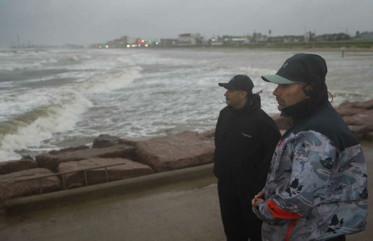 Jaime Ybarra, right, and his friend Frank Rivera watch their lines as they fish as Tropical Storm Nicholas moves towards the Texas coast Monday, Sept. 13, 2021, along the seawall in Galveston.