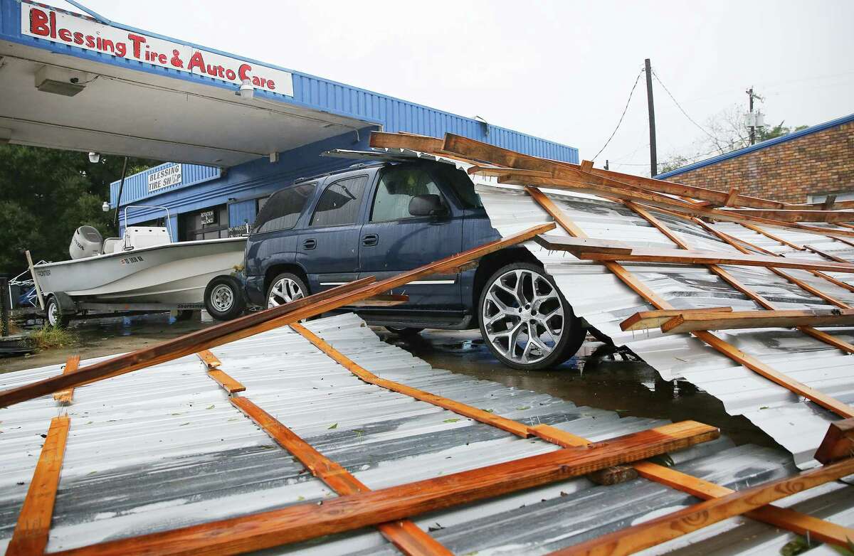 A roof on top of a car parked at Blessings Tire and Auto Care following Hurricane Nicholas in Bay City on Tuesday, Sept. 14, 2021. According to the owner of the business, he wasn't sure where the roof came from.