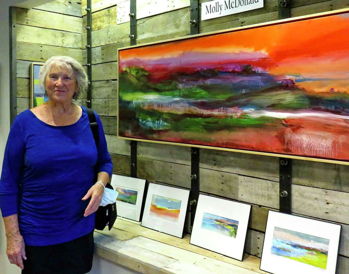Above, Painter Molly Sullivan McDonald at opening for BACA fall gallery exhibit on Branford’s Main Street. At right,