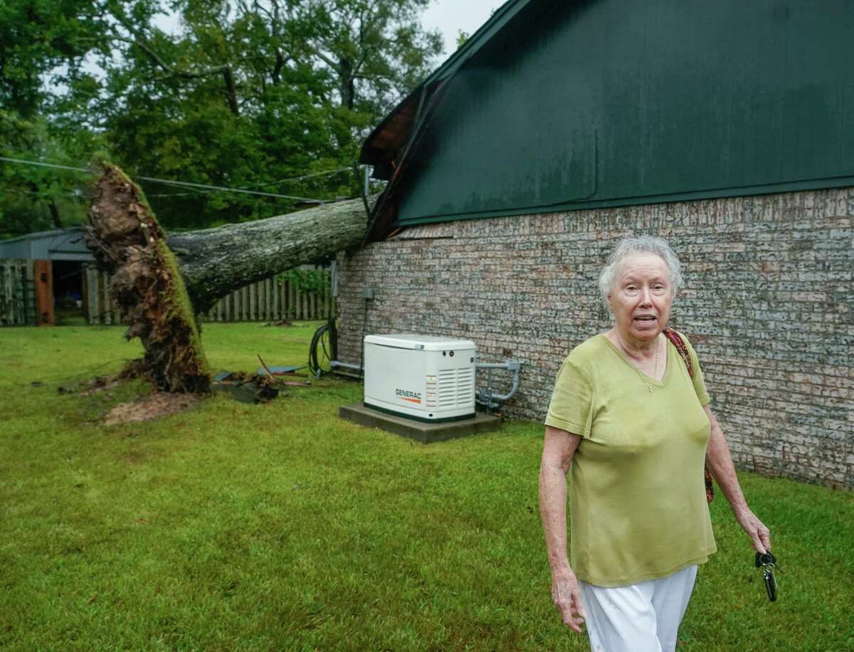 Marie Davis looks at the damage caused by a tree which was knocked over into her home during Tropical Storm Nicholas, on Tuesday, Sept. 14, 2021, in Baytown. This is the third time a tree has fallen into Davis' home; hurricanes Alicia and Ike were the prior two occurrences.