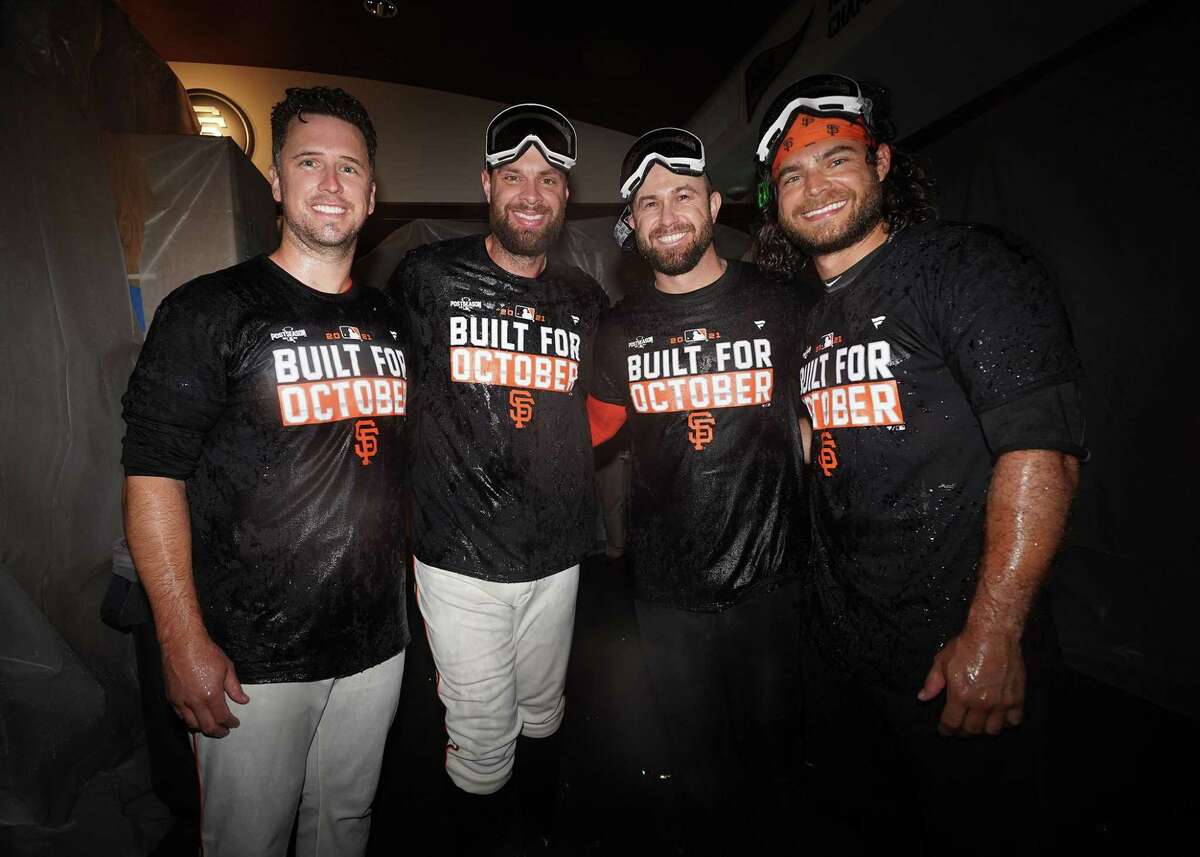 The San Francisco Giants celebrate in the clubhouse after clinching a playoff berth at Oracle Park in San Francisco, Calif., on Monday, September 13, 2021.