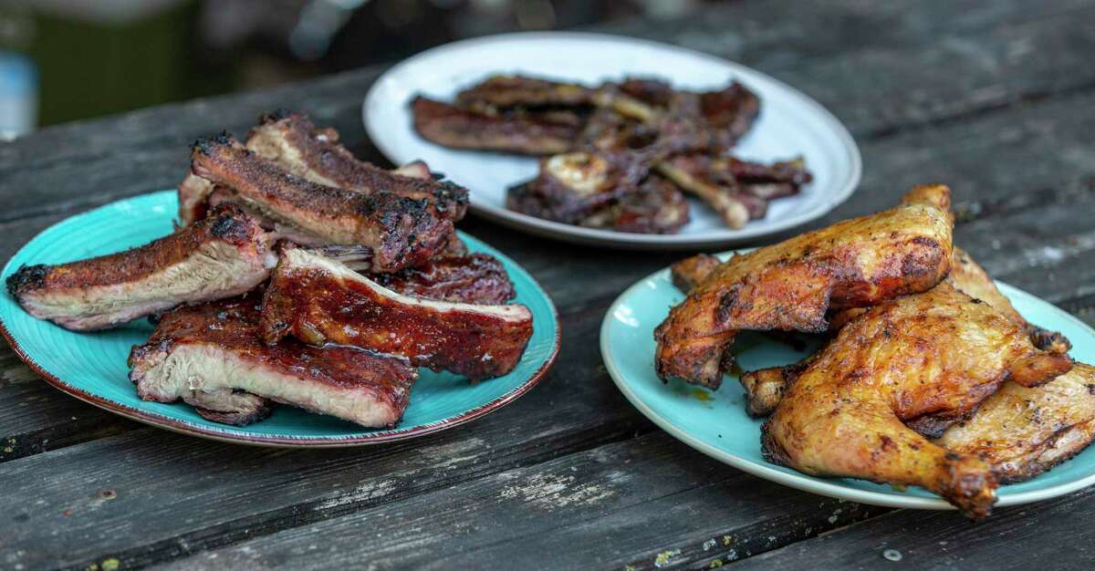 Pork ribs, from left, beef ribs and chicken mopped with fruit blends are displayed at Chuck's Food Shack. Fruit jellies can replace barbecue sauces when cooking meats.