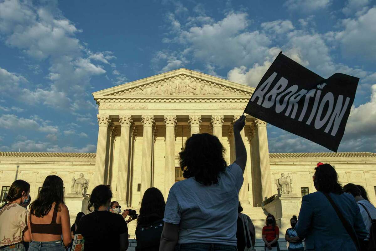 Abortion rights advocates demonstrate outside the Supreme Court in Washington, Sept. 9, 2021. There is little precedent for the provision that deputizes ordinary citizens to enforce an effective ban on abortions — and offers them a financial incentive to do so. (Kenny Holston/The New York Times)