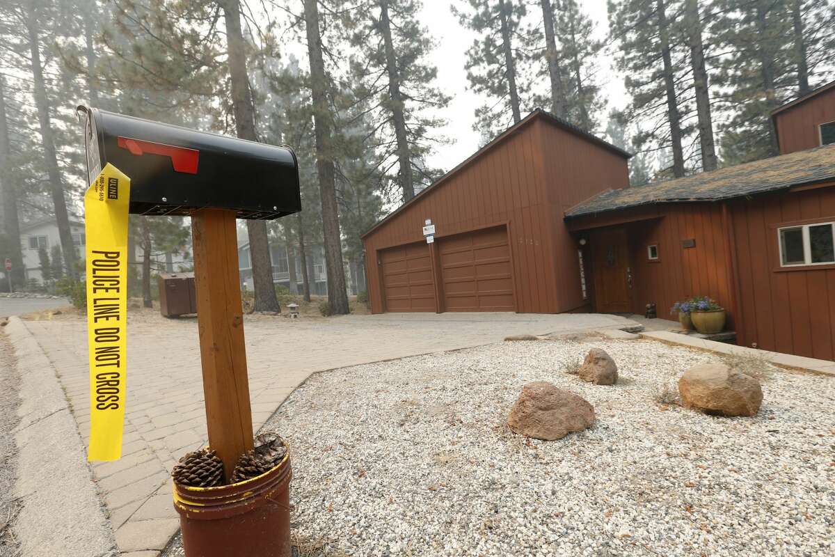 A tagged home is seen off Pioneer Trail as the Caldor Fire burns nearby in South Lake Tahoe, Calif., on Thursday, Sept. 2, 2021. More than 20,000 residents were evacuated.