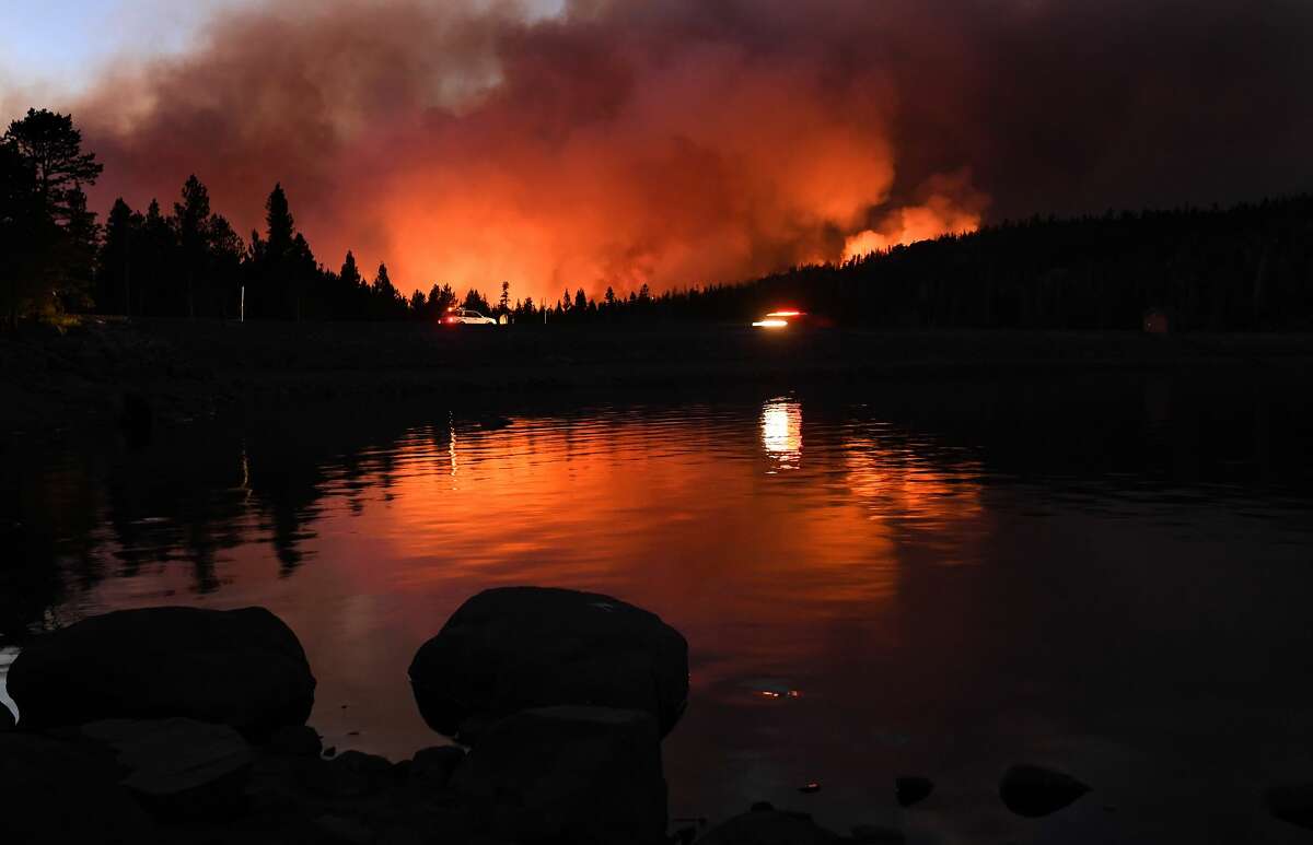 The Caldor fire is reflected off of Caples Lake near Kirkwood ski resort on Aug. 31, 2021.