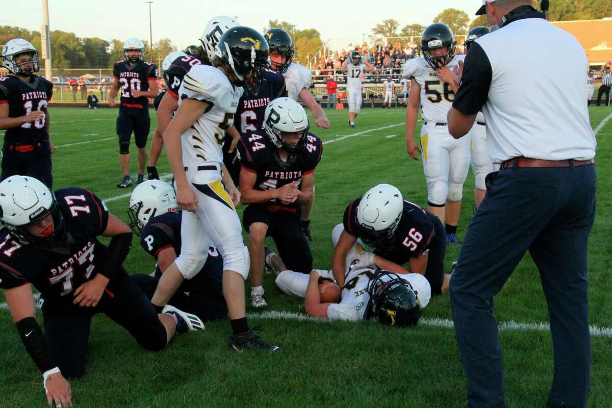 Colin Fitzpatrick is tackled by a host of USA defenders. (Tom Greene/Huron Daily Tribune)