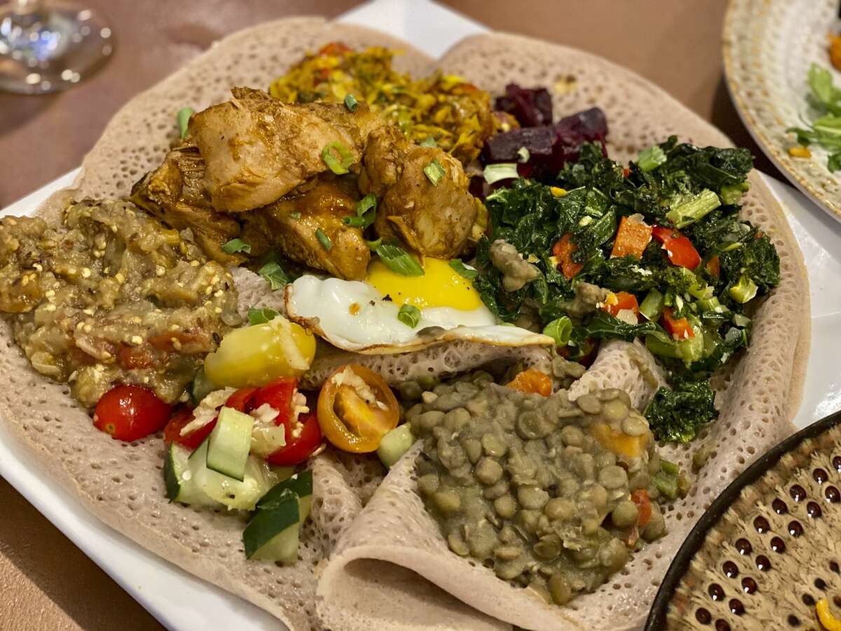 Portions of meats and salads layered on top of injera, the classic Ethiopian spongy, teff-fermented crepe, now appear nightly on the menu at Umana Yana, a newly reopened Albany restaurant featuring Afro-Caribbean cuisine.