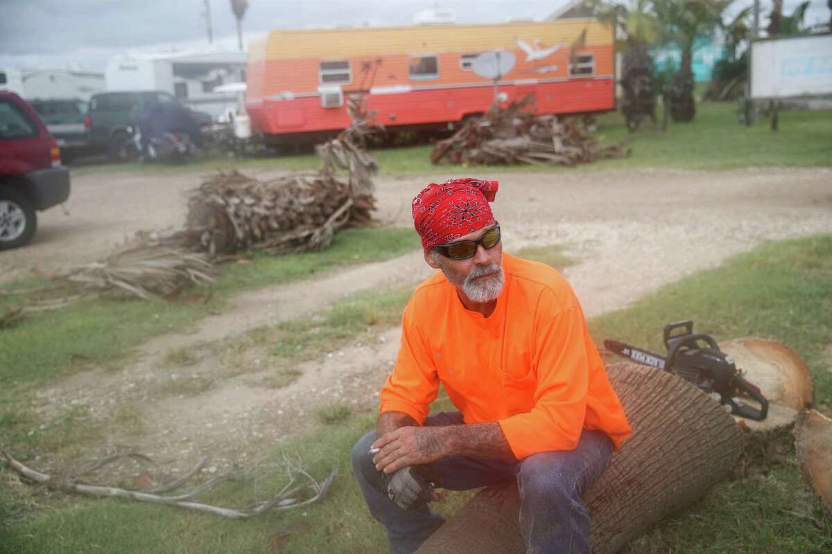 Morris Womack takes a break while cutting down palm trees Tuesday, Sept. 14, 2021, in Surfside Beach. “My trailer just rocked a little bit,” he said of Hurricane Nicholas’ landfall earlier that morning.