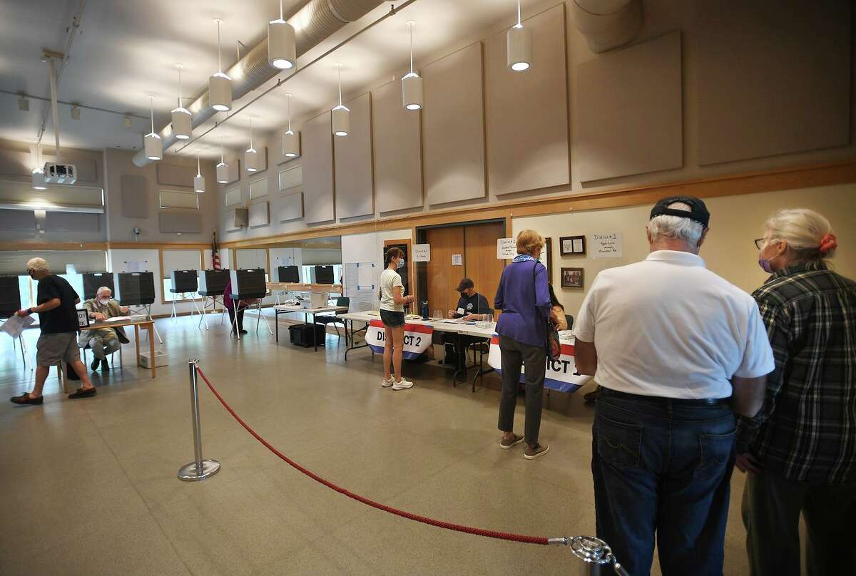 Voters cast their ballots in Tuesday’s Democratic primary for first selectman at the Redding Community Center in Redding.