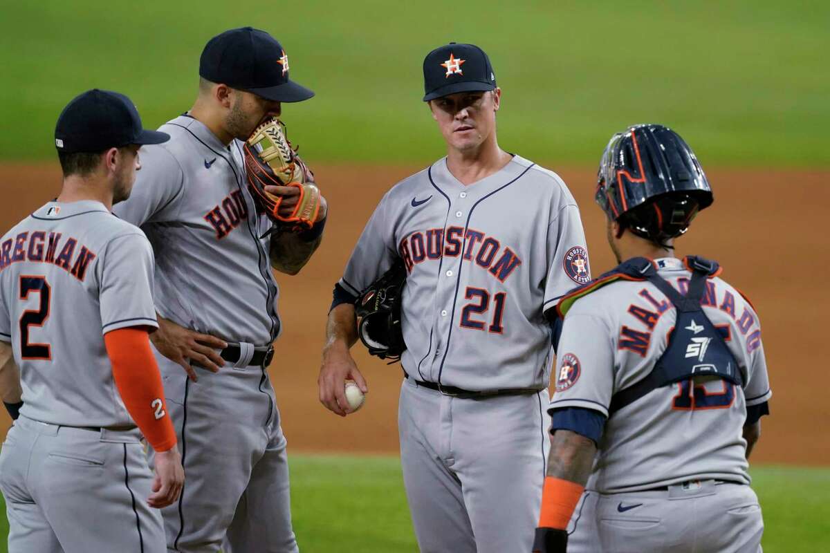 Houston Astros' Alex Bregman (2), Carlos Correa, second from left, starting pitcher Zack Greinke (21) and catcher Martin Maldonado gather on the mound during the sixth inning of the team's baseball game against the Texas Rangers in Arlington, Texas, Tuesday, Sept. 14, 2021. (AP Photo/Tony Gutierrez)