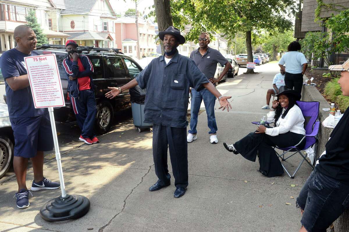 City Council member Ernie Newton stands with supporters outside Dunbar School, in Bridgeport, Conn. Sept. 14, 2021. Newton seeks to continue representing the 139th district in Tuesday’s Democratic primary.