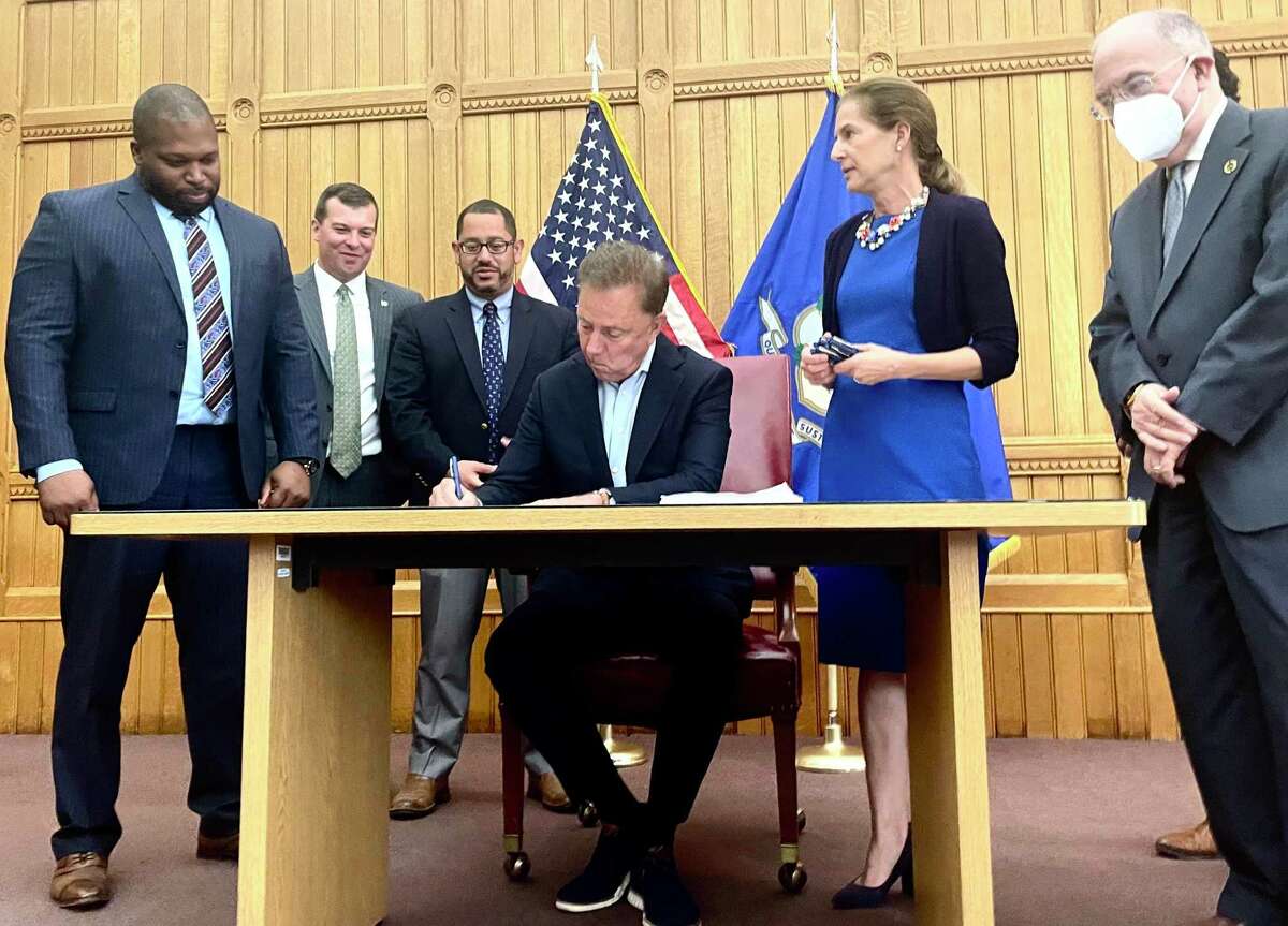 Gov. Ned Lamont signed a bill on June 22 making recreational marijuana legal for adults in Connecticut starting July 1. From left are proponents Sen. Gary Winfield, D-New Haven; Rep. Steve Stafstrom, D-Bridgeport; House Majority Leader Jason Rojas, D-East Hartford; Lamont; Lt. Gov. Susan Bysiewicz; and Senate President Pro-Tem Martin Looney, D-New Haven.