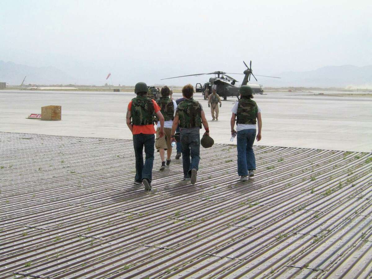 Members of the band Edisun prepare to board a chopper in Baghram, Afghanistan during one of their many concert tours in the Middle East. The band is the subject of a new documentary, “Bulletproof Wings,” now streaming on Tubi.