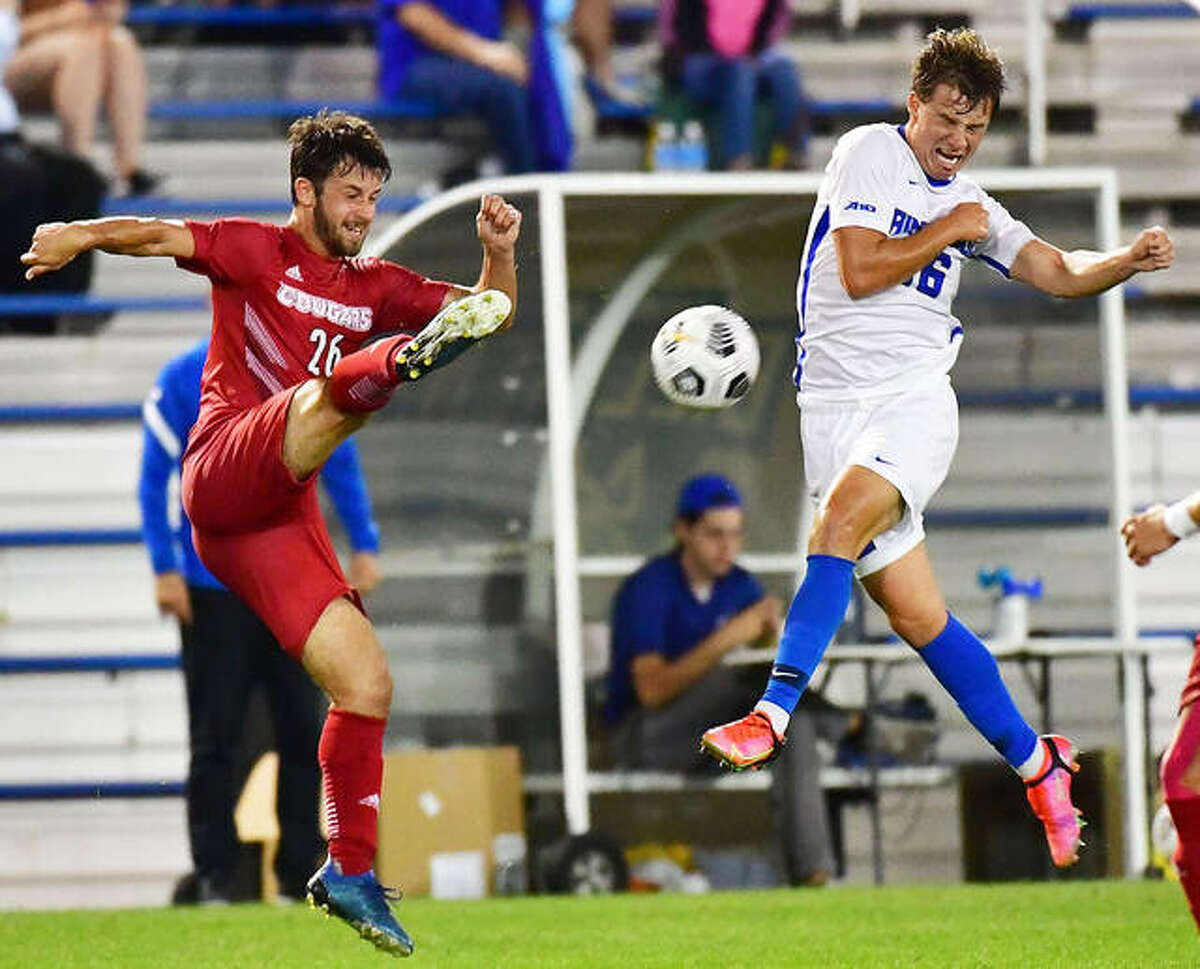 Seth Anderson of Saint Louis University, right, winces as Corban McAvinew volleys a shot during Tuesday night’s Bronze Boot Game at Hermann Stadium.