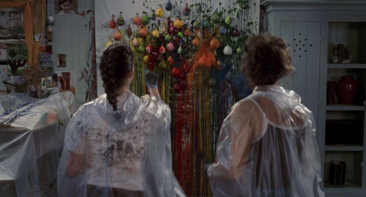 Mia (Anne Hathaway) and Helen Thermopolis (Caroline Goodall) throw darts at paint-filled balloons in a fan-favorite scene of 