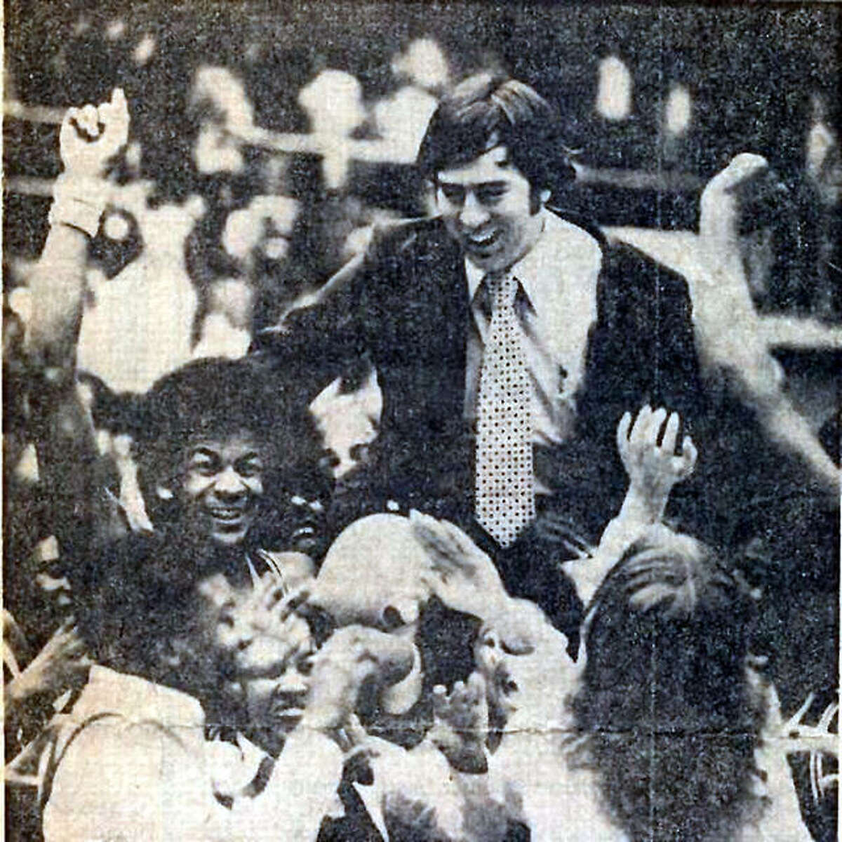 Coach Larry Graham is carried off the court by Madison Trojans team and fans after winning the Vandalia Class A Sectional championship in 1978 on their way to the Class A state championship. Graham, who went on to lead Madison to another state title before moving to SIUE, died a year ago at the age of 77. A Celebration of Life golf outing in his memory is set for Oct. 8 at Arlington Greens Golf Course near Granite City.